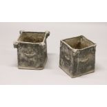 A PAIR OF 19TH/20TH CENTURY LEAD PLANTERS, of square shape, with rams head corners and classical