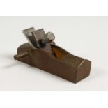 A MINIATURE BRONZE CARPENTERS PLANE. 3.5ins long.