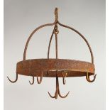 AN EARLY WROUGHT IRON GAME HANGER. 11.5ins diameter.