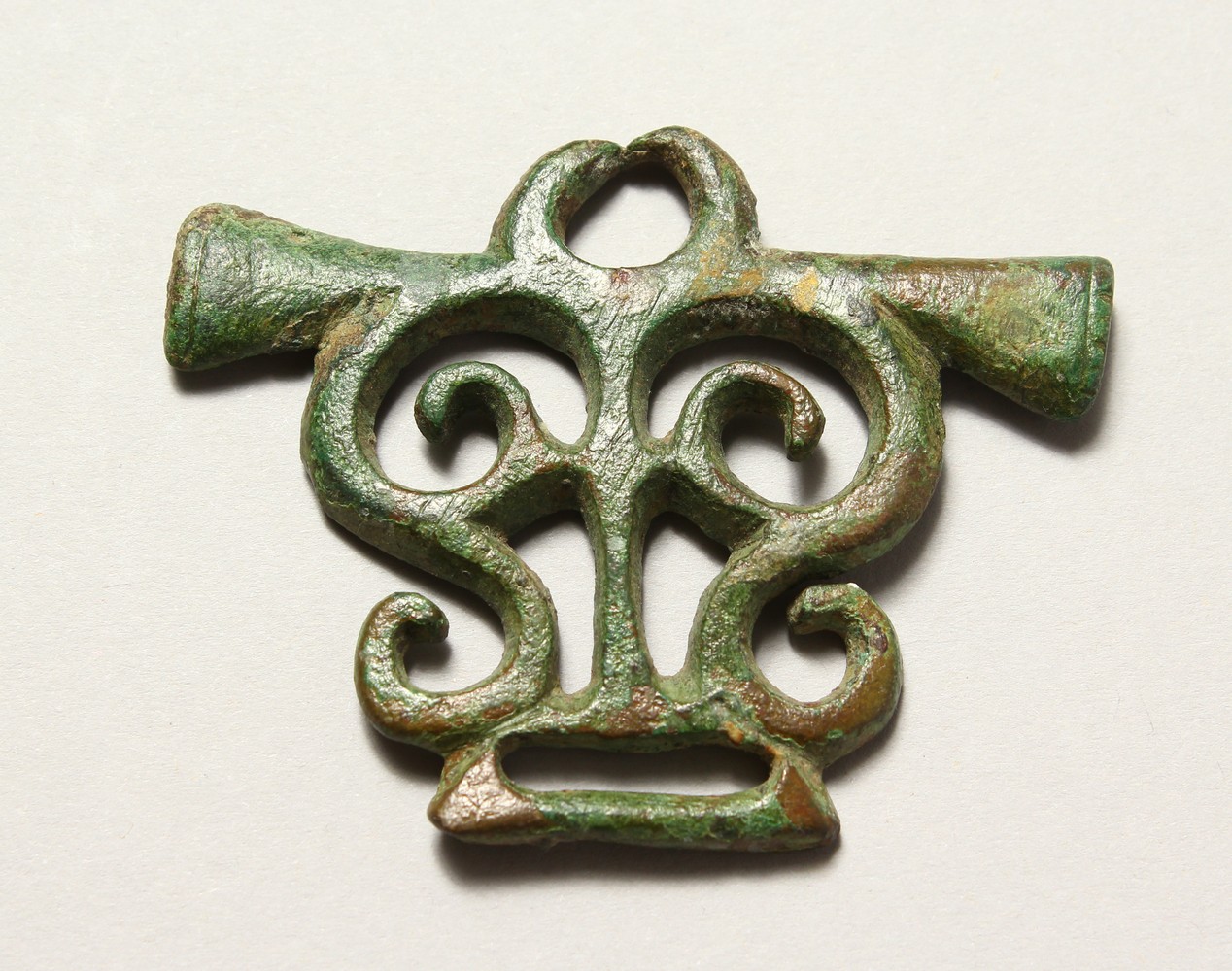 A ROMAN PIERCED BRONZE AMULET/BUCKLE. 3ins wide.