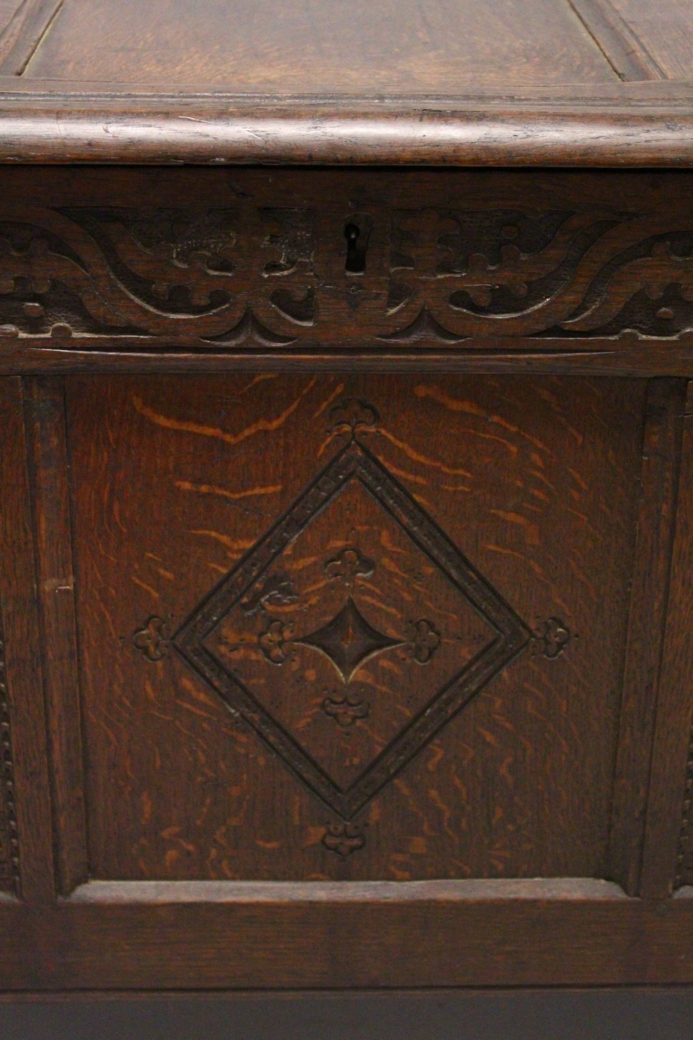 AN 18TH CENTURY OAK COFFER, with triple panelled top and front, with carved decoration. 4ft 3ins - Image 2 of 4