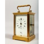 A BRASS CARRIAGE CLOCK, striking on a gong. 5ins high.