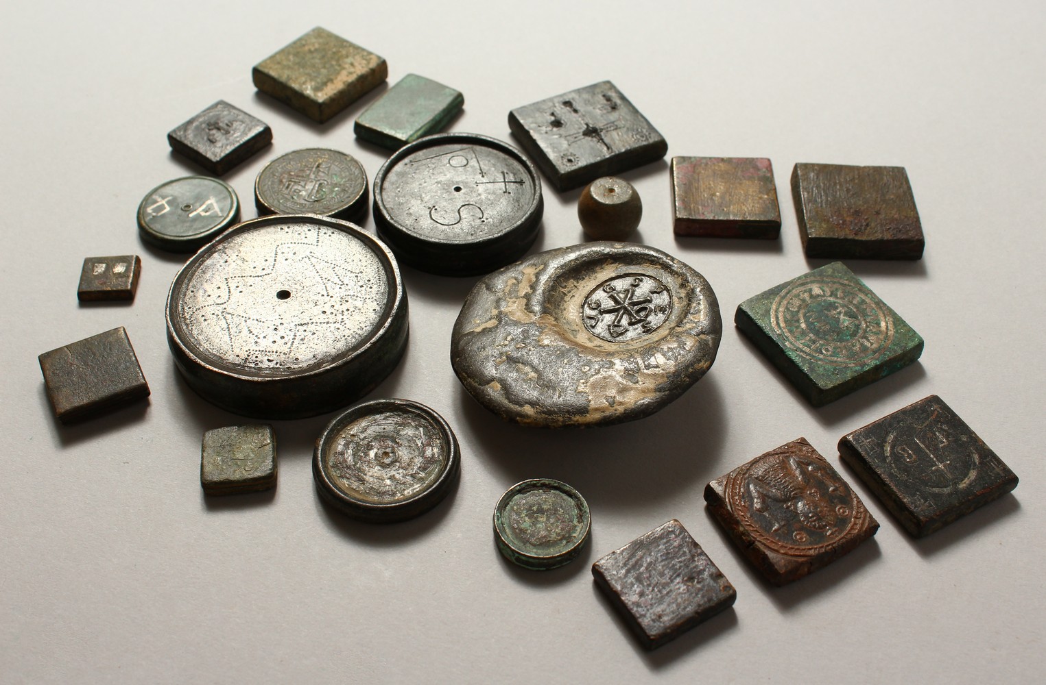 A COLLECTION OF TWENTY-ONE BYZANTINE BRONZE RECTANGULAR AND DISC WEIGHTS. Various Sizes.