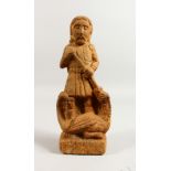 A CARVED STONE FIGURE, depicting George slaying the dragon. 11.5ins high.