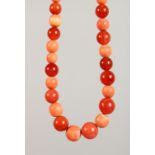 A CORAL AND CORNUCOPIA BEAD NECKLACE. 28ins long.