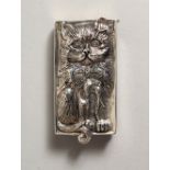 A RECTANGULAR CAST SILVER VESTA depicting a cat. 2ins long.