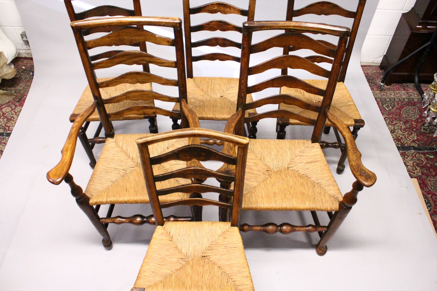 A MATCHED SET OF SIX 19TH CENTURY ASH AND ELM LADDER BACK DINING CHAIRS, two with arms, with rush - Image 8 of 8