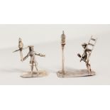 TWO CAST SILVER MINIATURE DUTCH FIGURES, lamp lighter and man with bird. 1.75ins high.
