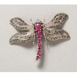 A SILVER AND RUBY MARCASITE DRAGONFLY BROOCH.