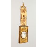 A SMALL HANGING BEDSIDE/TRAVELLING CLOCK, with gilt metal mounted tapestry hanger and frame. Clock