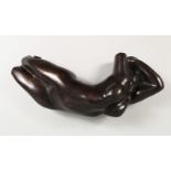 AFTER AUGUSTUS RODIN A BRONZE RECLINING FEMALE NUDE. 15ins long.