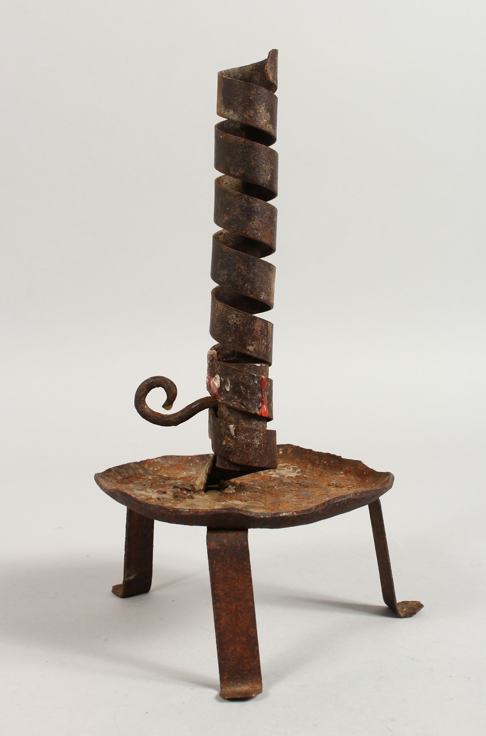 AN EARLY WROUGHT IRON CANDLESTICK. 9.5ins high.