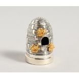 A CAST SILVER BEEHIVE PIN CUSHION.