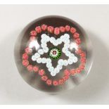 A CLICHY PAPERWEIGHT, with star shape Millefiori design. 2.75ins diameter.