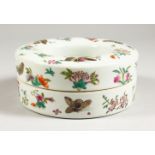 A CHINESE CIRCULAR PORCELAIN BOX AND COVER, painted with butterflies. 6ins diameter.