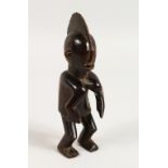 A GOOD SMALL CARVED WOOD TRIBAL FIGURE OF A MAN, possibly Senufo Tribe. 7.5ins high.