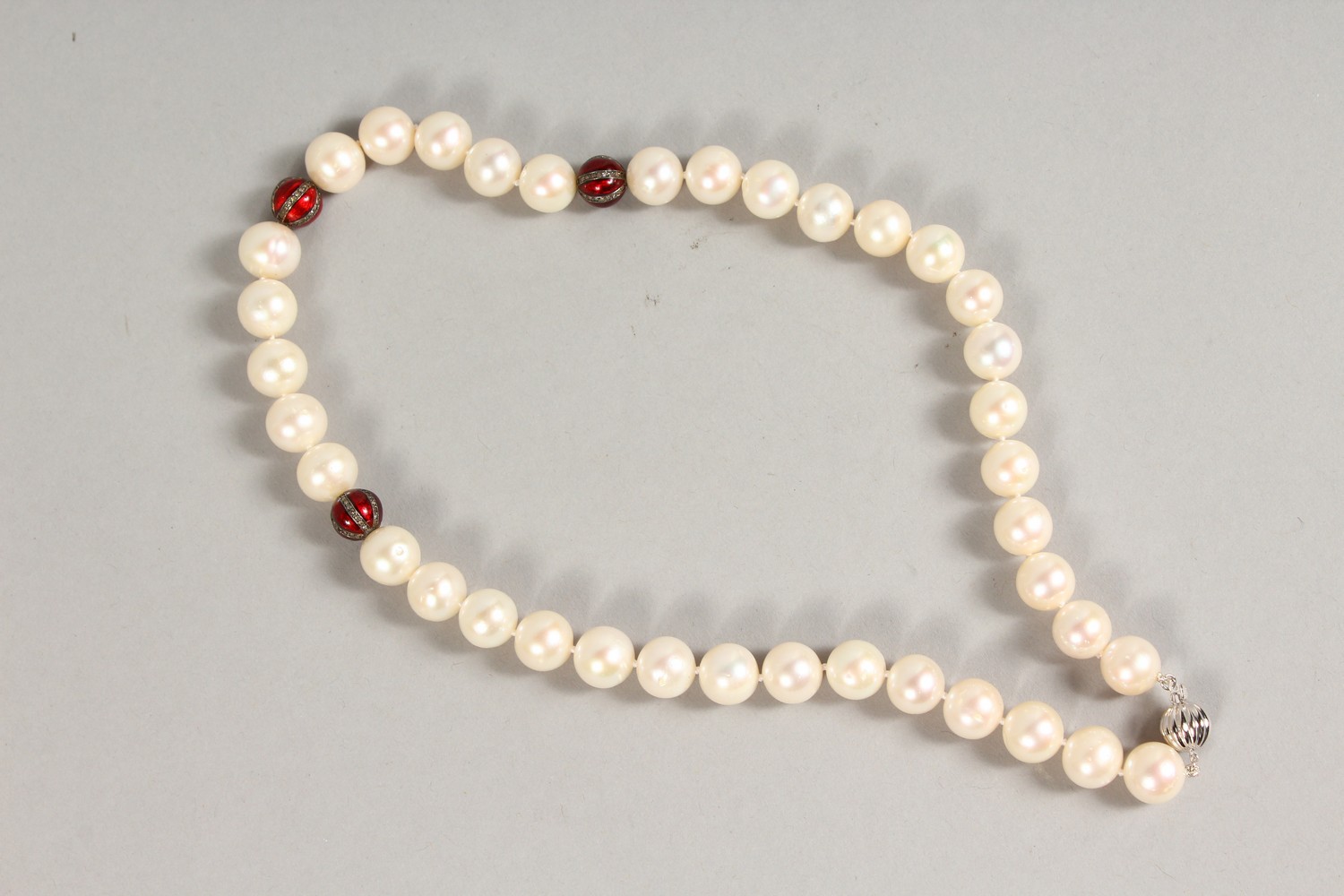 A PEARL NECKLACE, with three diamond and enamel sections and 18ct gold clasp. 18ins long. - Image 3 of 5