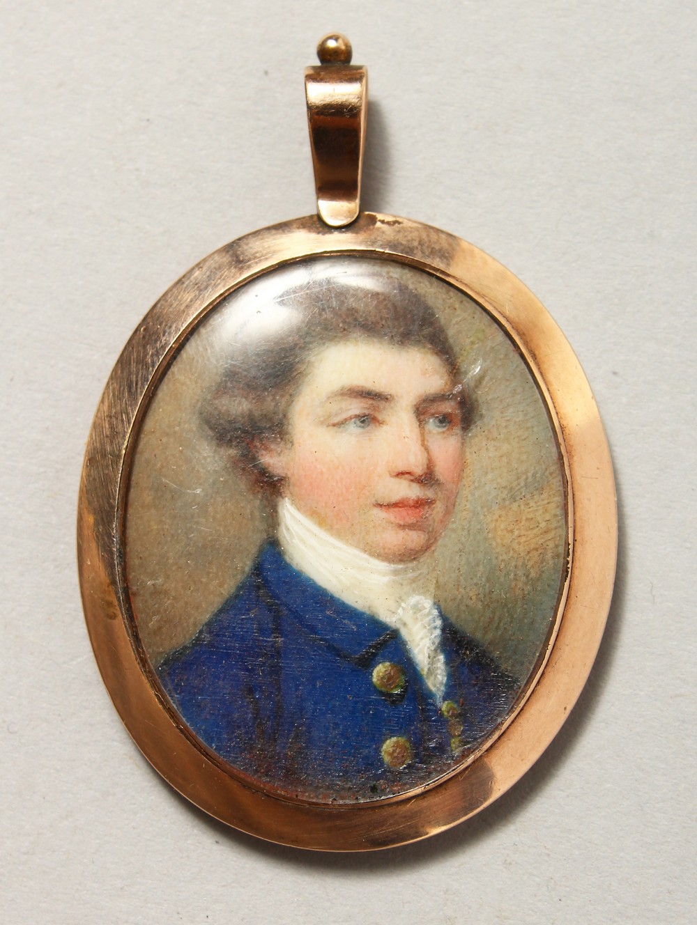 18TH CENTURY ENGLISH SCHOOL Head and shoulders of a young man in a blue coat and white cravat. 1.