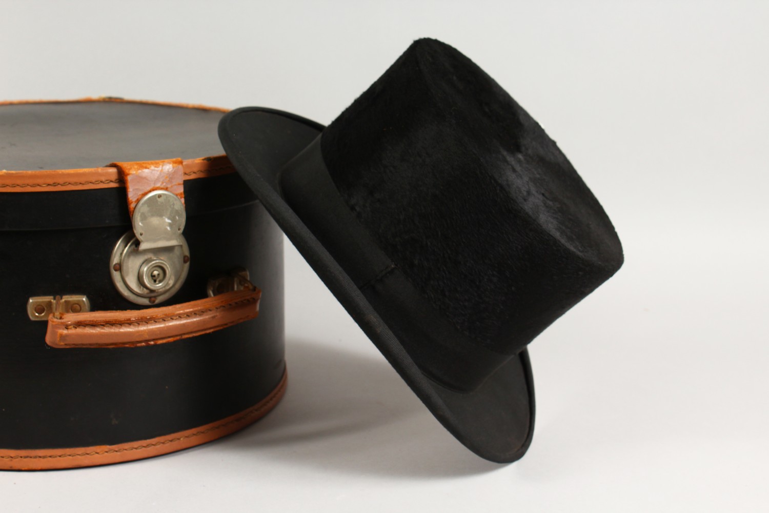 AN OLD TOP HAT, in a circular hat box.