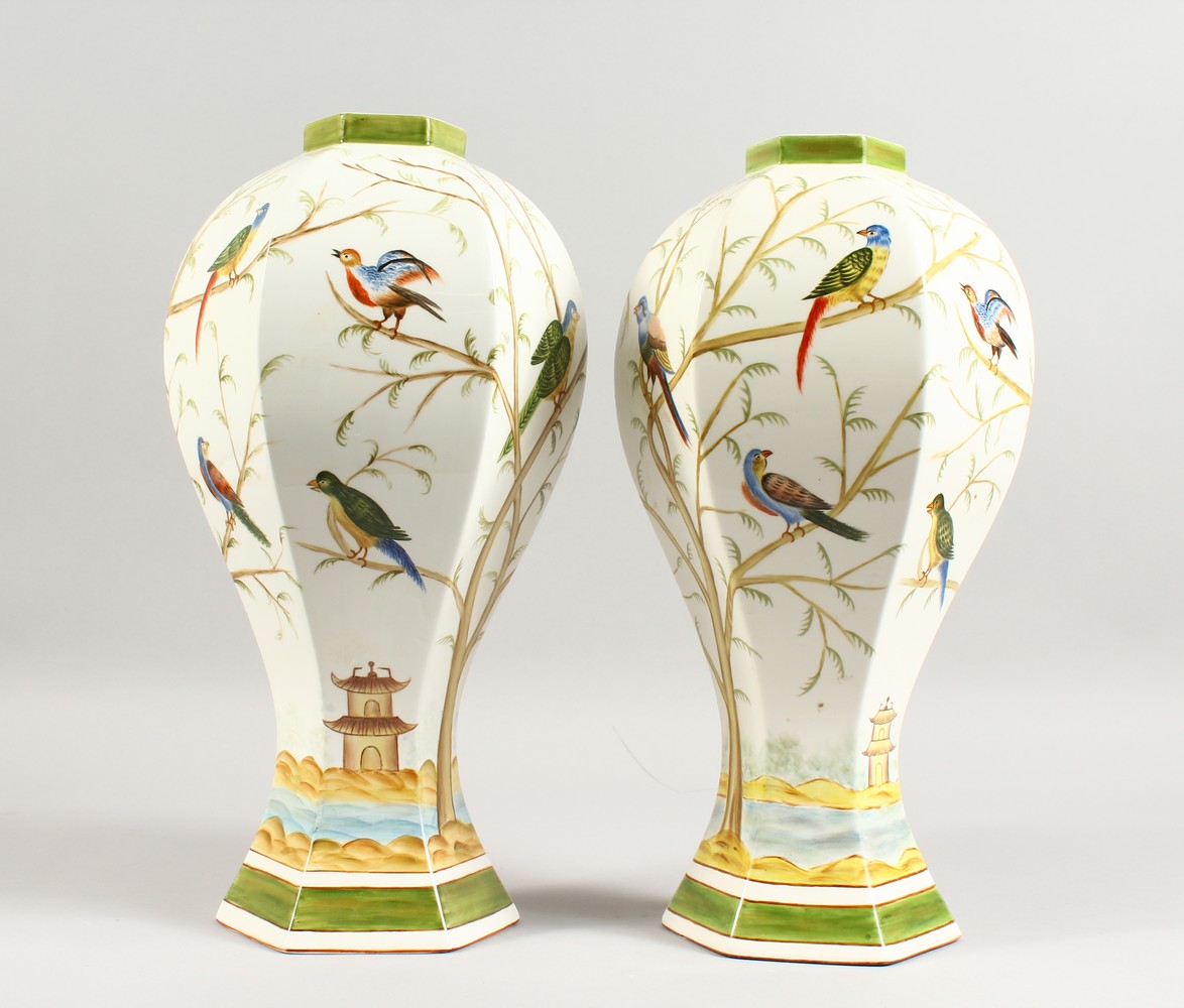 A PAIR OF HEXAGONAL BALUSTER SHAPED VASES, decorated with exotic birds. 14.5ins high.