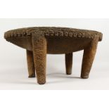 AN UNUSUAL PRE-COLUMBIAN CARVED STONE "METATE" FEEDING BOWL, on four legs. 26ins long x 17.5ins wide