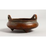 A CHINESE BRONZE SMALL TWIN-HANDLED CENSER. 3.5ins diameter.