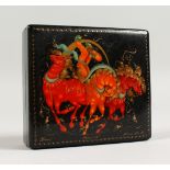 A RUSSIAN LACQUER BOX, decorated with a figure riding three horses. 4ins x 3.5ins.