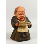 A PAINTED TERRACOTTA TOBACCO JAR, modelled as a monk. 10ins high.