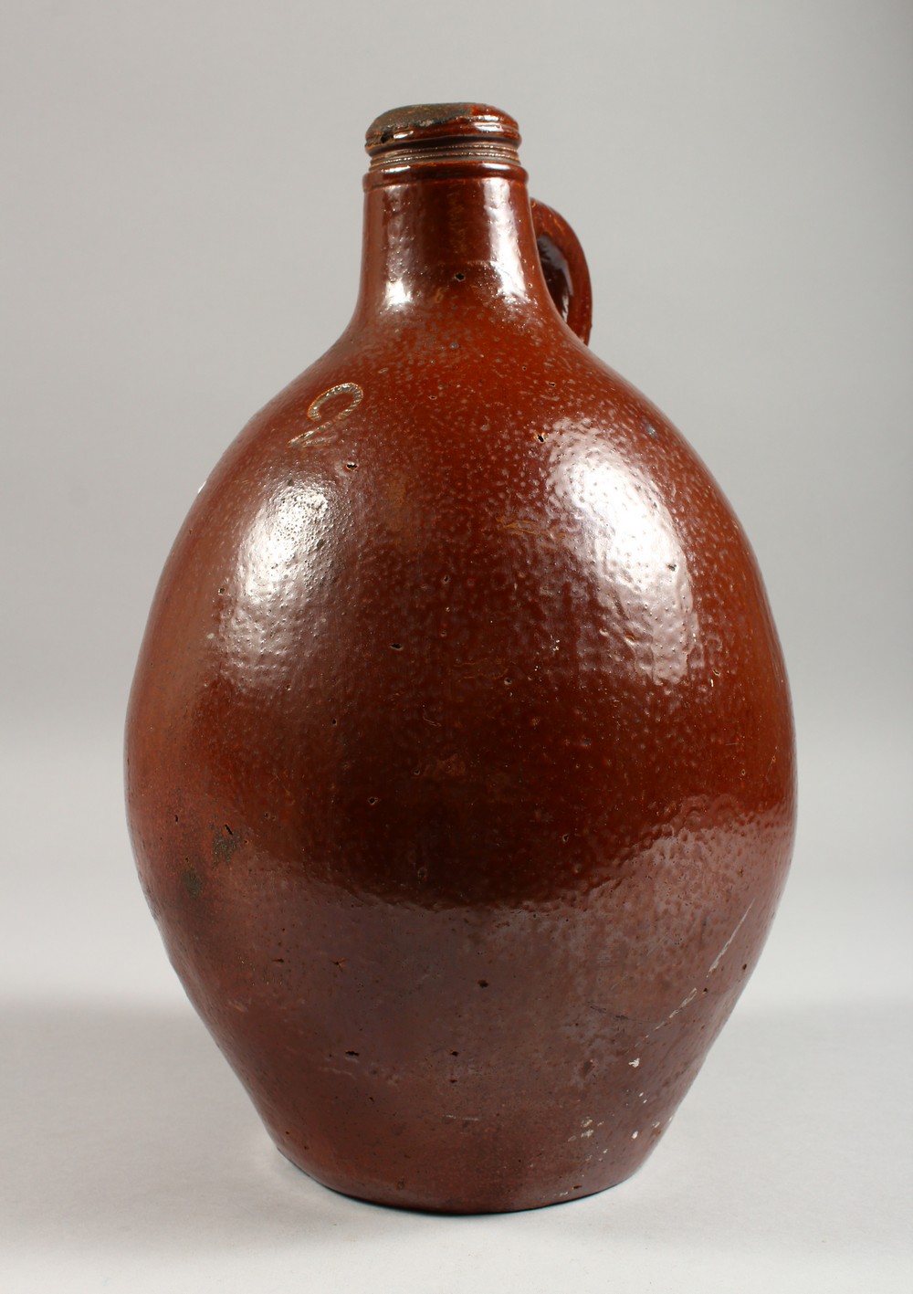 A LARGE BELLARMINE STYLE STONEWARE JUG. 13.5ins high.