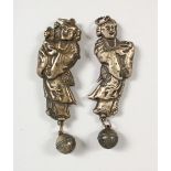 A PAIR OF CHINESE SILVER FIGURAL RATTLES. 3ins high.