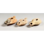 THREE ROMAN TERRACOTTA OIL LAMPS.