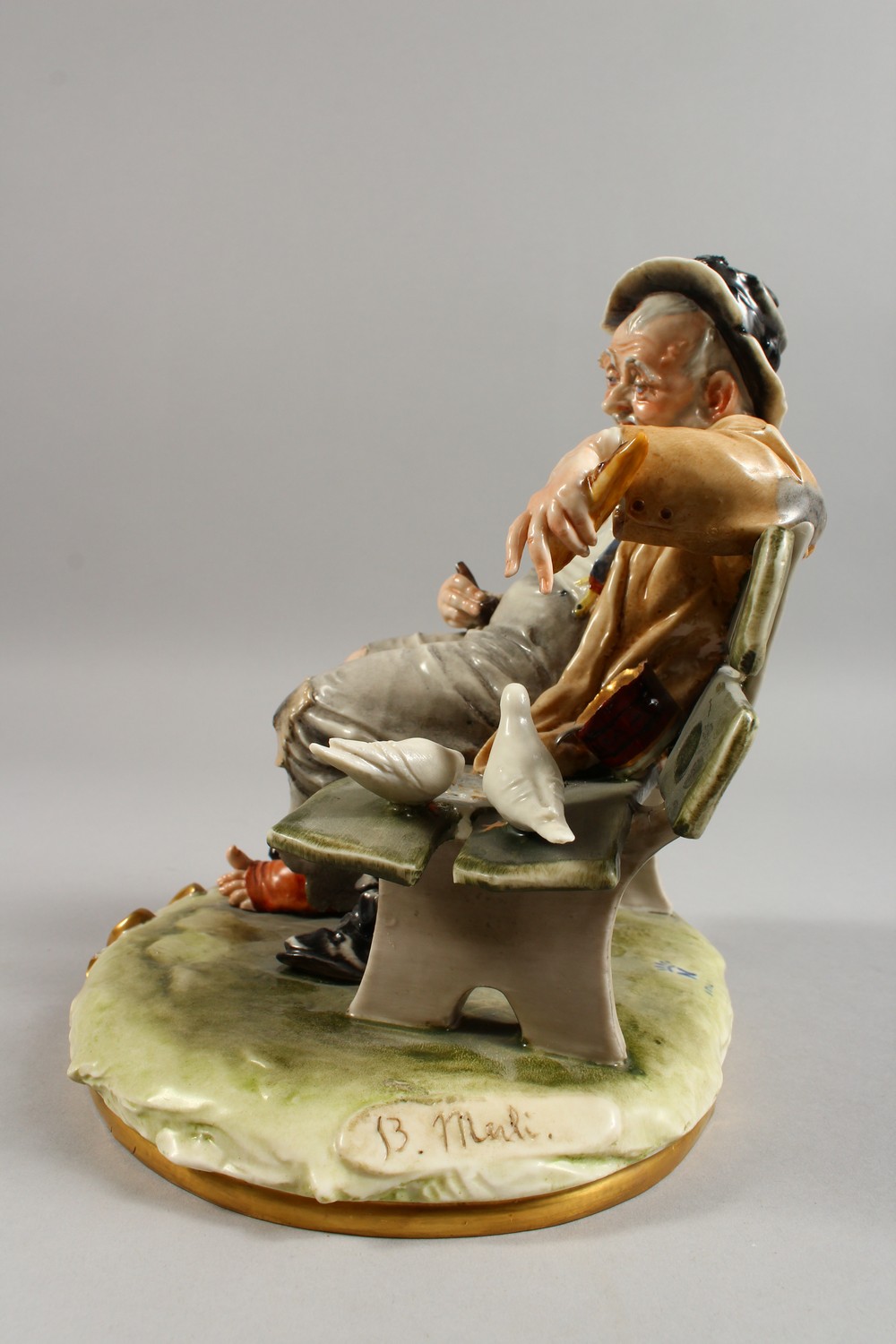 A CAPODIMONTE GROUP, a tramp seated on a bench, feeding two doves. 9ins wide. - Image 9 of 11