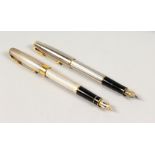 A GOOD SET OF TWO PARKER PENS with gold nibs.