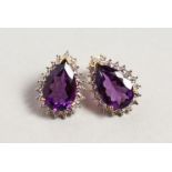 A PAIR OF 9CT WHITE GOLD PEAR SHAPED AMETHYST AND DIAMOND EARRINGS.