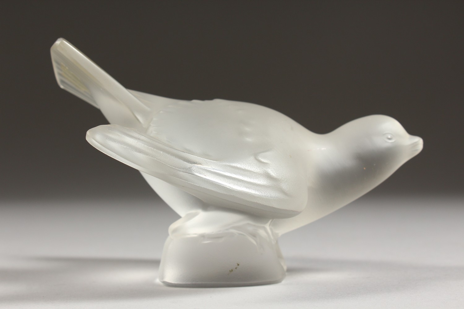 A LALIQUE FROSTED GLASS MODEL OF A BIRD, wings outswept, (base chipped). 5ins long. - Image 2 of 7