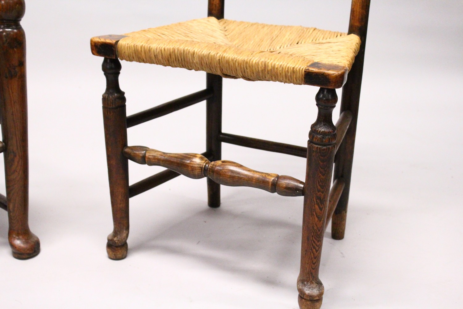 A MATCHED SET OF SIX 19TH CENTURY ASH AND ELM LADDER BACK DINING CHAIRS, two with arms, with rush - Image 2 of 8