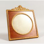 A SMALL EMPIRE STYLE GILT METAL PHOTOGRAPH FRAME, with ornate crestings. 6.5ins high x 5.5ins wide.