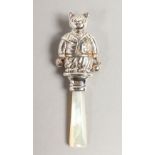 A SILVER CAT SHAPED RATTLE.