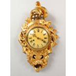 A FRENCH STYLE GILTWOOD CARTEL WALL CLOCK. 23ins high.