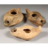 THREE ROMAN TERRACOTTA OIL LAMPS.