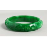 AN APPLE GREEN JADE BANGLE. 3ins diameter.