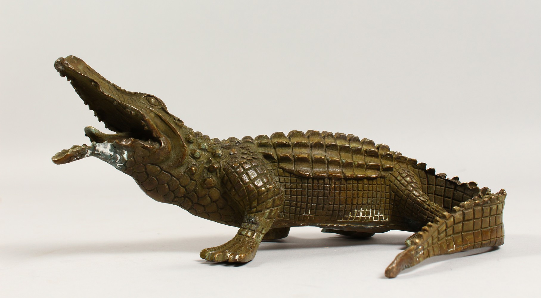 A BRONZE MODEL OF A CROCODILE. 9.5ins long.