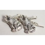 A PAIR OF SILVER MICHELIN MAN CUFFLINKS.