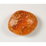 A NATURAL PIECE OF AMBER, 28g. 2ins wide.