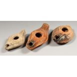 THREE ROMAN TERRACOTTA OIL LAMPS.