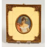 AN OVAL PORTRAIT MINIATURE, young lady wearing a white dress, in an ivorine and gilt metal frame.