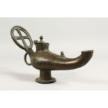 A LARGE BYZANTINE LIDDED BRONZE LAMP with Cruciform handle. 10ins long.