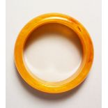 AN AMBER BANGLE.