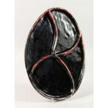 MARIA CHRISTINA TUGENDHAT, a black glazed free form oval shaped dish, with four sections.