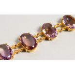 A GOOD SILVER AND GOLD PLATE BRACELET SET WITH FOUR LARGE AMETHYSTS.